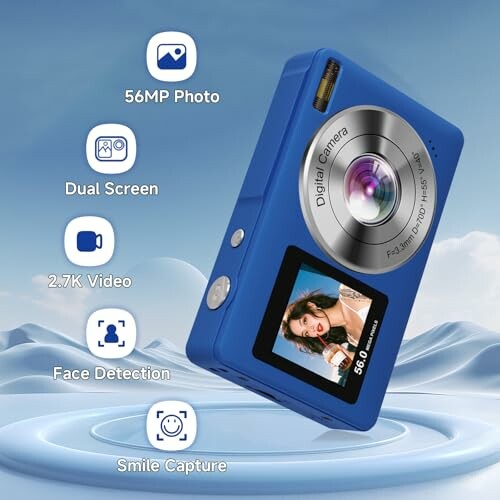 Blue digital camera with dual screen, 56MP photo, 2.7K video, face detection, and smile capture features.