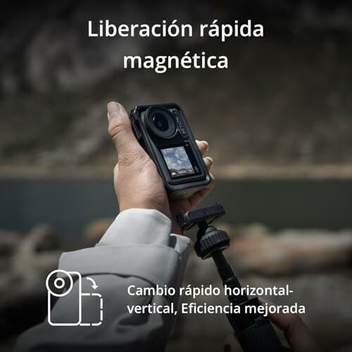 Hand holding a camera with magnetic quick release feature.